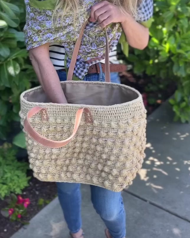 Boucle Natural Crochet Straw Basket Bag handmade woven raffia palm fiber in a solid hue of natural straw color in a supple nub/ball texture of horizontal bands around the bag with link weave around the top and loop crochet edging on the bottom and top plus leather handles beach bag shoulder bag purse - Shebobo