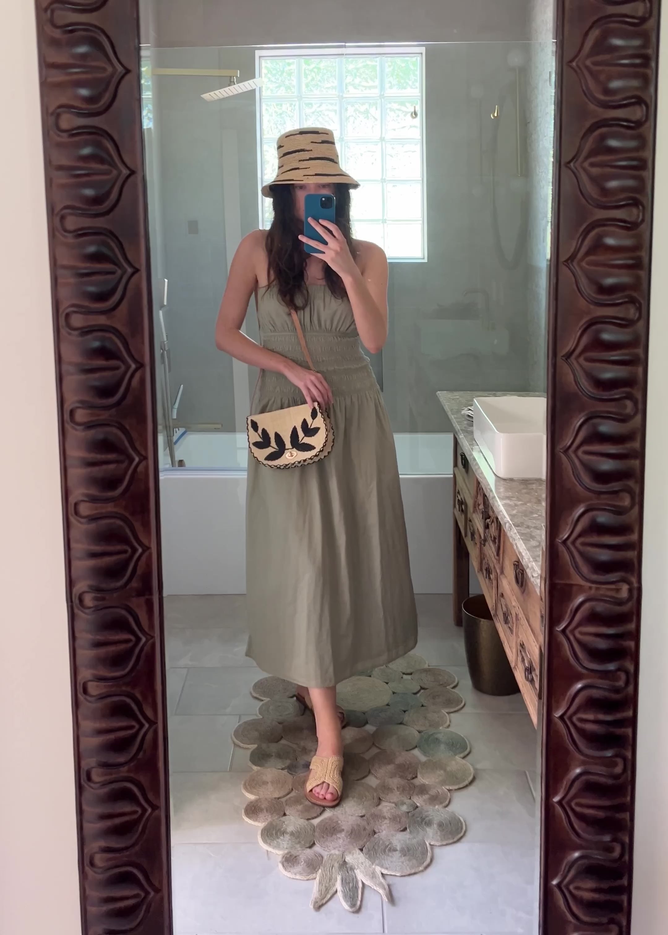 Model wearing 70's Crossbody Straw Bag handmade loomed natural raffia palm fiber purse with black accent cross stitch edging and matching leaf design embroidery handbag with adjustable leather strap - Shebobo (with Taylor Zebra Stripe Bucket Straw Hat)