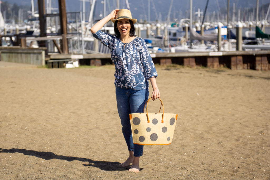 Model wearing Capri Polka Dots Straw Tote Bag natural loomed raffia with dot pattern - Shebobo