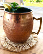 Detail view Imani Crochet Raffia Coasters set of four handmade natural raffia palm fiber crochet in a solid hue of natural straw color table setting protectors with brushed fringe edge with a spiral circular subtle texture - Shebobo