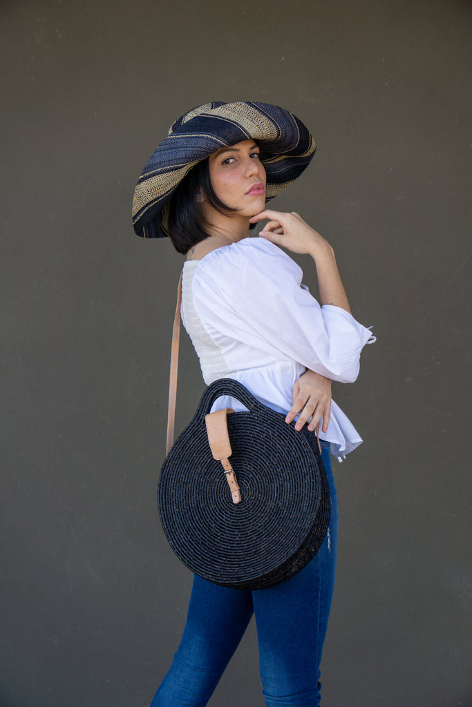 Model wearing size large Luna Black Round Straw Crossbody Bag modern crochet raffia handmade purse shoulder bag - Shebobo