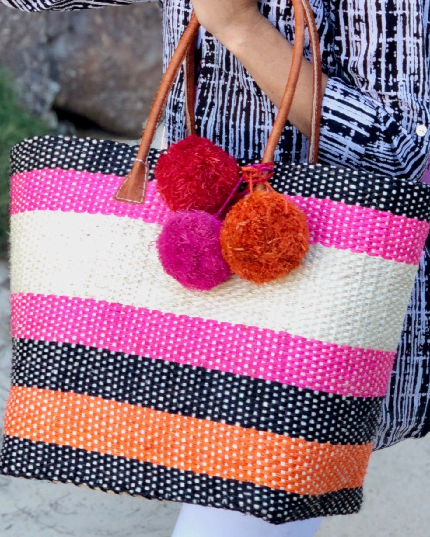 Lifestyle photo of three multicolored single raffia poufs handmade single pompom bag charm embellishments sold as singles - Shebobo