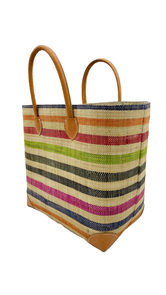 Side View Rayo Stripes Straw Basket Bag Multi Stripe handmade loomed natural raffia palm fiber in a horizontal stripe pattern of even widths of natural straw color alternated with multiple colors of navy dark blue, fuchsia pink, black, lime green, red, orange, etc. handbag with leather handles tote beach bag - Shebobo