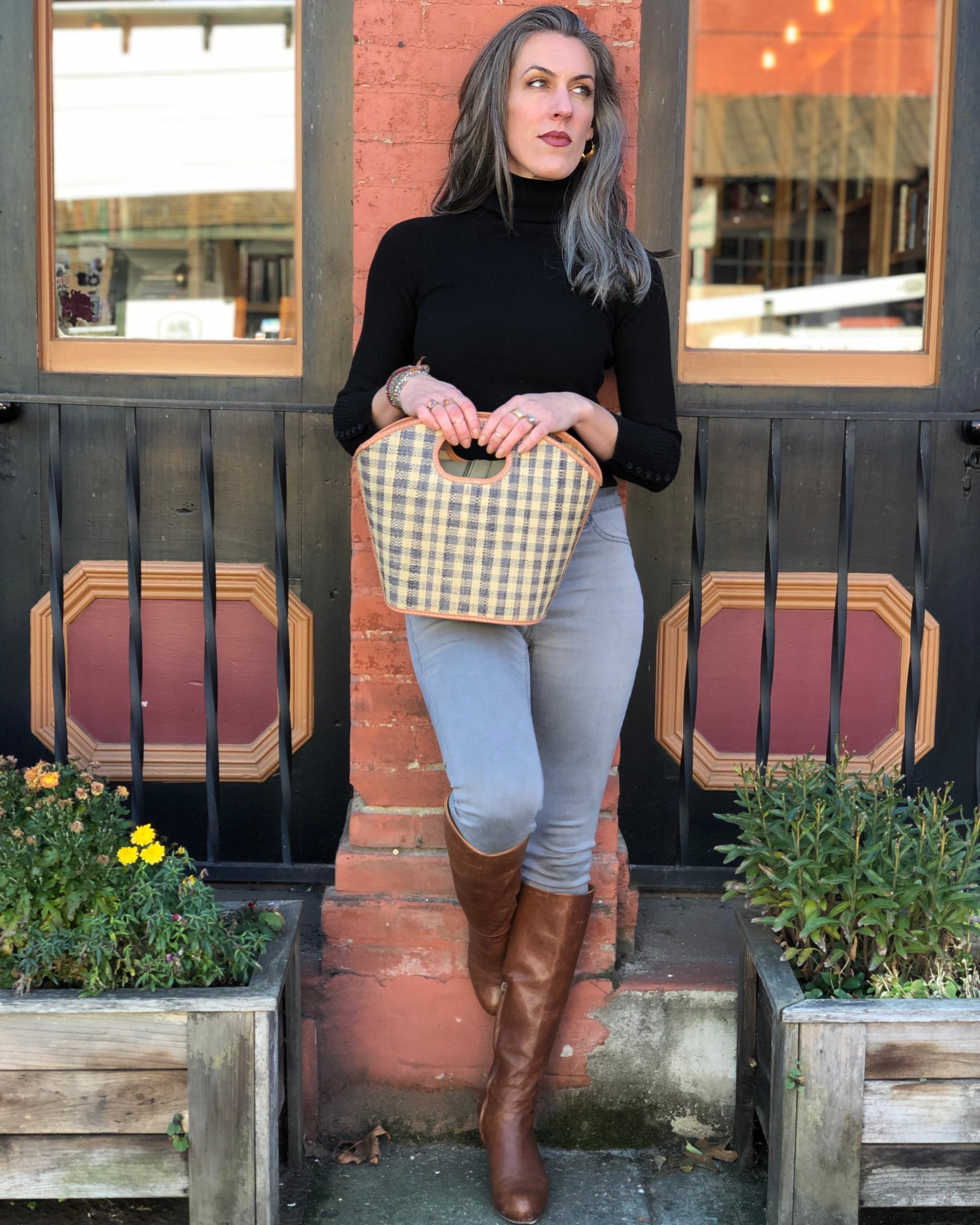 Model wearing Ricky Straw Bucket Handbag handmade loomed raffia in grey and natural gingham plaid pattern with leather finishes purse - Shebobo