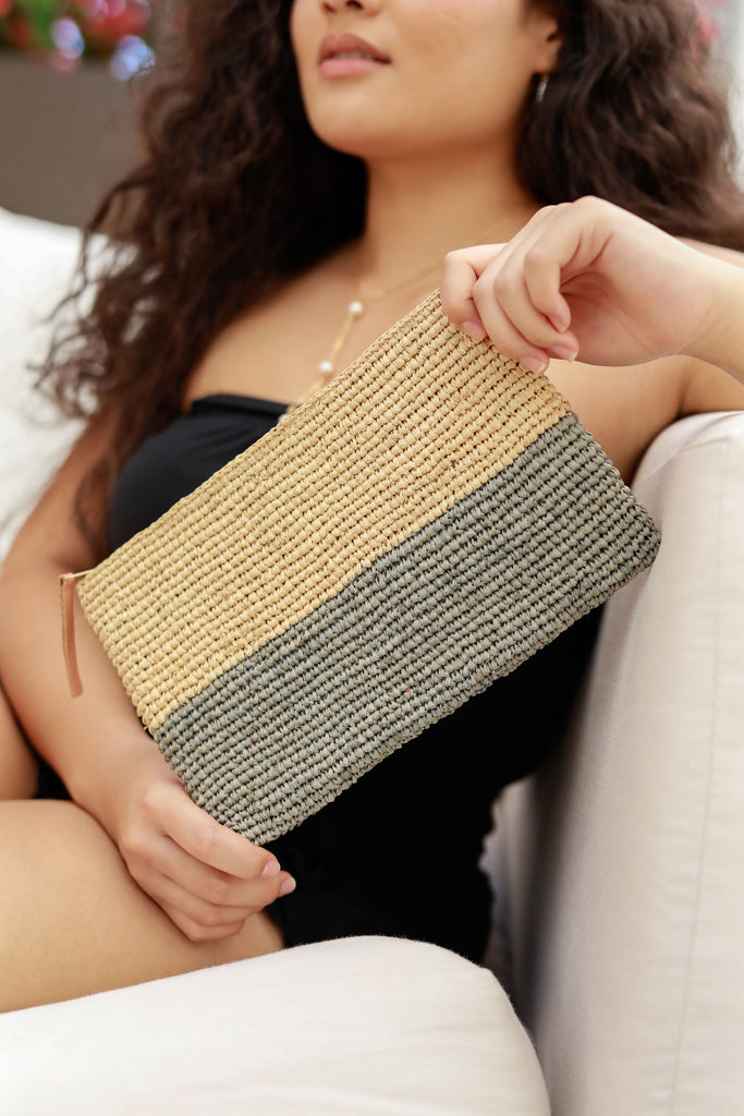 Model wearing Stella Two Tone Crochet Straw Clutch handbag color block natural raffia top with soft grey bottom handmade purse with zipper closure and leather pull pouch bag - Shebobo