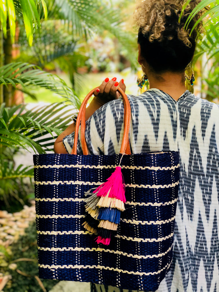 Model wearing sample bag with Tassels Fiesta Multicolor Layered Raffia Tufts Charm handmade bag embellishment or decor fuchsia pink, natural straw, navy blue, grey, black, and cinnamon/tobacco/brown fringed layered tufts tassel - Shebobo