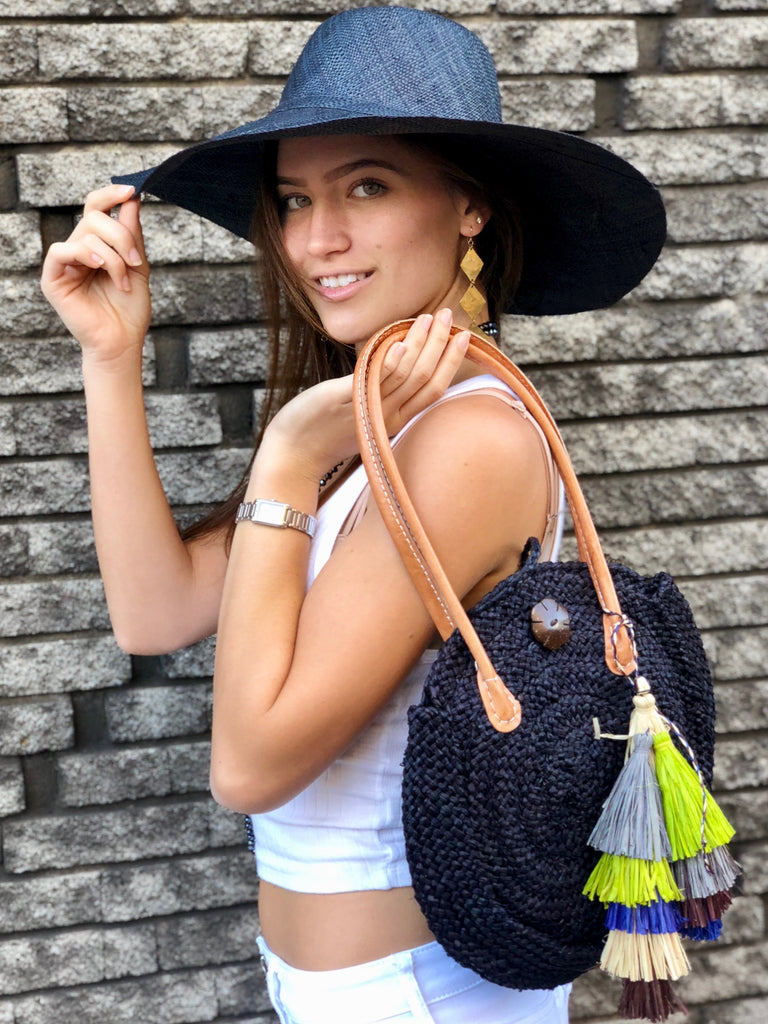Model wearing sample bag with Tassels Yerba Multicolor Layered Raffia Tufts Charm handmade bag embellishment or decor natural straw color, lime green, grey, navy blue, and cinnamon/tobacco/brown fringed layered tufts tassel - Shebobo