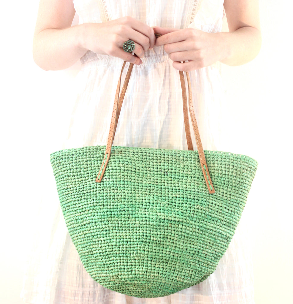 Model wearing Tika mint green hand crochet raffia straw handbag purse with leather handles bag - Shebobo